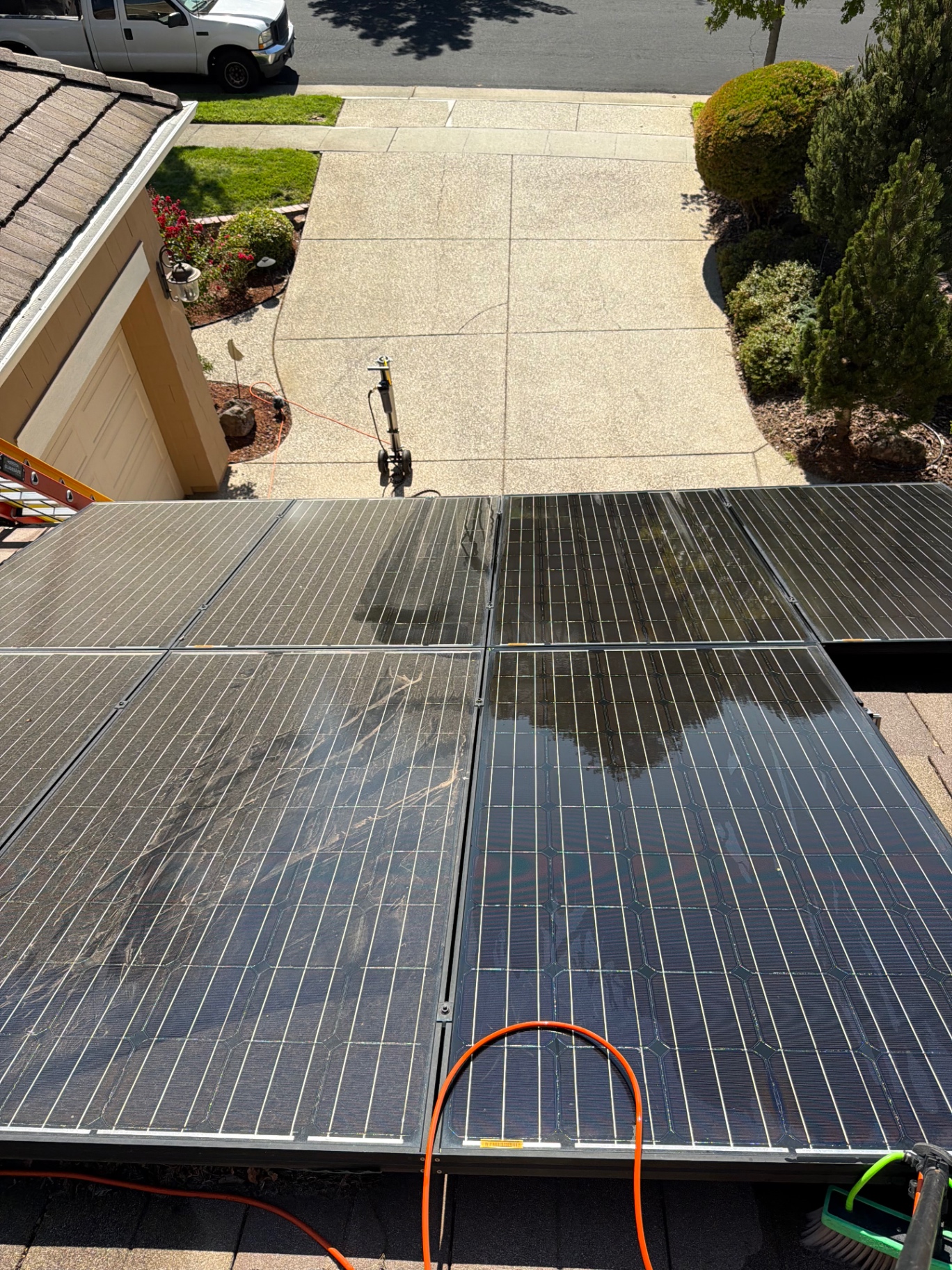 Rooftop solar panels half dirty and half professionally cleaned by Summit Exterior Enterprises